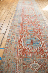 Distressed Karaja runner showcasing geometric motifs in cherry red, sky blue, and ivory.