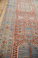 Distressed Karaja rug's geometric patterns, pale cherry red, sky blue, faint foundation.