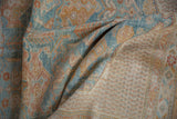 Distressed Afshar rug with worn blue and gold floral patterns and visible foundation.