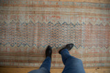 A view of the distressed Mahal runner's soft texture and time-worn pile in terracotta and blue.
