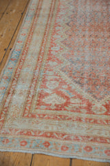Angled view of the vintage Mahal runner's distressed pile worn to its hand-knotted foundation.