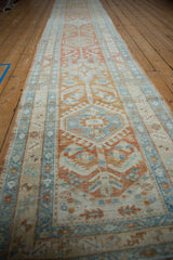 Distressed Heriz runner's geometric floral designs with subtle wear and soft colors.