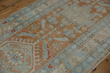 Distressed geometric floral motifs in pale terra cotta and powder blue Heriz rug.