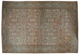 Distressed vintage Mahal carpet with allover floral palmettes in faded rose, slate, and sand tones.