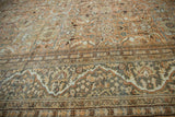 Distressed vintage Mahal carpet with sandalwood floral field and meandering Safavid dragon border.