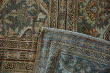 Distressed Mahal rug corner, highlighting texture and a Safavid-inspired dragon border motif.