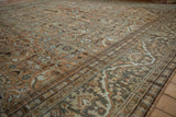 Distressed Mahal carpet: Safavid-inspired dragon motif border and muted floral field pattern.