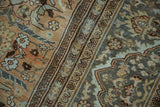 Distressed Mahal carpet pile showing dusty rose floral field and Safavid-inspired border motif.