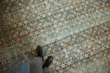 Distressed vintage Tabriz carpet, allover Herati floral pattern in dusty teal and terra cotta, with visible foundation.
