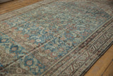 Distressed vintage Malayer carpet with worn Herati motifs and varied abrash tones.