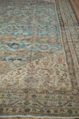Distressed Malayer carpet, showing dusty sky blue abrash, Herati motif, and worn texture.