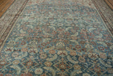Close-up of distressed Malayer carpet, dusty sky blue Herati motif, abrash, and even wear.
