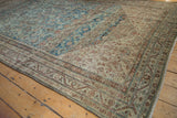 Distressed Malayer rug displaying traditional floral arabesque and vine borders, dusty blue, ivory.