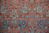 Worn knots and distressed texture of a vintage Bijar carpet with a ruby and blue floral pattern.