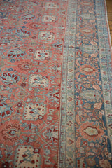 Detailed palmette and floral motifs on the distressed ruby red field and powder blue border.