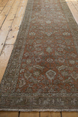 Distressed Northwest Persian runner showing floral cross section, dusty terra cotta, and faint foundation.