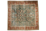 Distressed Sarouk square carpet, deep ocean green field, playful floral motifs, rustic red border.