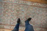 Distressed vintage Hamadan runner with pale blue, silver, and earthy red Herati patterns underfoot.