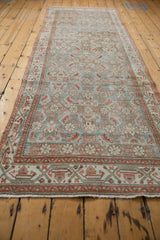 Vintage distressed Hamadan runner showcasing faded Herati design in dusty blue and red.