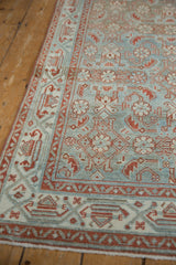 Distressed Hamadan runner detail: faded Herati pattern in dusty pale blue, silver, and brick red serbend border.