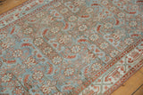 Detail of vintage distressed Hamadan rug with dusty pale blue and rust Herati motif, showing even wear.