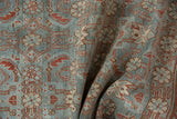 Distressed vintage Hamadan rug detail, Herati pattern in dusty blue, ivory, and reddish-brown.