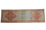 Distressed vintage Northwest Persian rug runner, triple geometric medallions in beige, faded red, pale blue.