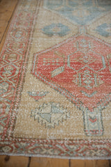 Distressed pale cherry red and powder blue serrated medallion on a vintage Northwest Persian runner.