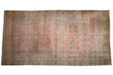 Sprawling antique Kermanshah carpet with a distressed allover design of arabesques in cochineal red and ivory.