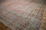 Inscribed weaver's signature cartouche on the floral border of a distressed antique Kermanshah carpet.