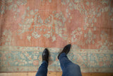 Distressed vintage Mahal rug underfoot, highlighting even wear, soft blue, and pale terra cotta floral designs.