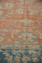 Distressed Persian Mahal rug pile showing abrashed terra cotta ground and soft blue florals.