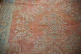 Distressed vintage Mahal carpet detail with floral sprays, abrashed terra cotta, and soft blue vine border.