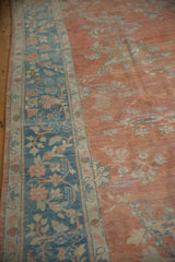 Distressed vintage Mahal rug with blue floral border and abrashed terracotta field.
