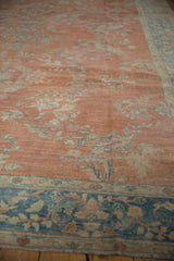 Distressed Mahal carpet's ruby red floral field, faint foundation, and blue vine border.