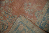 Distressed Mahal carpet detail, showing faint foundation through pale terra cotta floral field.