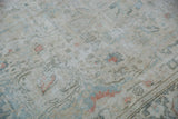 Distressed vintage Doroksh carpet showing foundation, faded floral design, and soft tones.