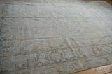 Distressed texture and soft shades on the Doroksh carpet's floral border.