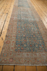 Traditional Malayer runner, showing distressed sapphire blue Herati field and floral pinwheel border.