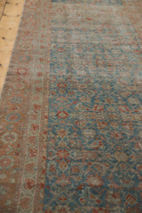 Distressed Malayer runner's worn pile, showing floral border, Herati motifs, blue and terracotta.