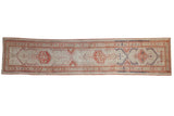 Distressed Serab runner with geometric terra cotta, ivory, and blue medallions. 2'11