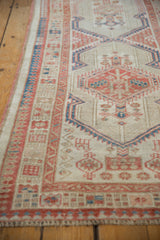 Angled close-up of vintage distressed Serab runner with geometric ivory, terra cotta, and blue patterns.