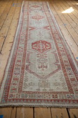 Detail of vintage distressed Serab runner with geometric ivory, terra cotta, and light blue patterns.