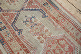 Textured detail of distressed Serab runner with geometric ivory, terra cotta, and blue motifs.
