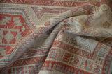 Distressed Serab runner's geometric pattern details and worn texture in terra cotta, ivory, and blue.