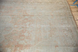 Faded floral motifs and distressed pile texture on a vintage Oushak carpet.