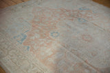 Distressed Oushak carpet pile showing pale copper, ivory, turquoise, and visible foundation.