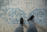 Distressed Persian Heriz carpet in powder blue and ivory, showing softened pile texture.