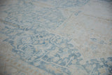 Distressed texture on vintage Heriz rug, powder blue and ivory floral motifs, faint foundation.