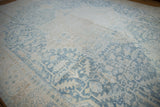 Vintage distressed Heriz carpet with softened powder blue and ivory floral field and border.